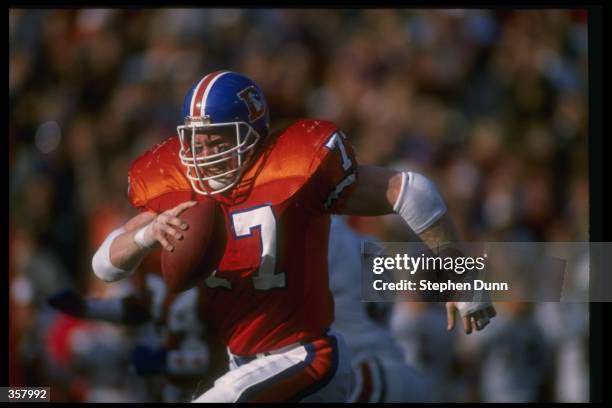 Defensive lineman Karl Mecklenburg of the Denver Broncos runs with the ball during a game against the Arizona Cardinals at Mile High Stadium in...