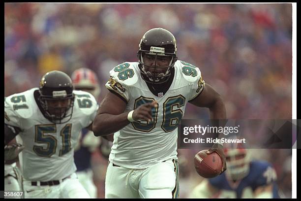 Defensive lineman Clyde Simmons of the Jacksonville Jaguars runs the ball for a touchdown during a playoff game against the Buffalo Bills at Rich...