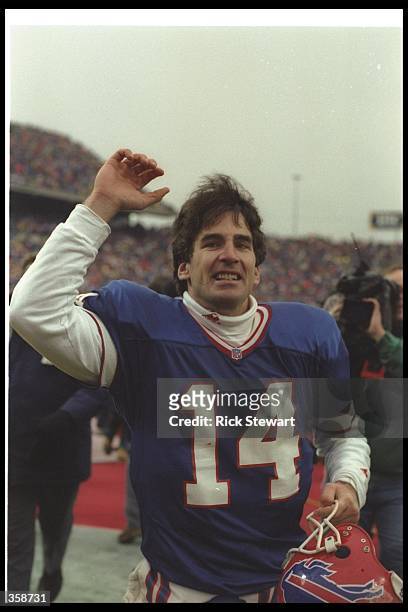 Quarterback Frank Reich of the Buffalo Bills celebrates after a playoff game against the Houston Oilers at Rich Stadium in Orchard Park, New York....
