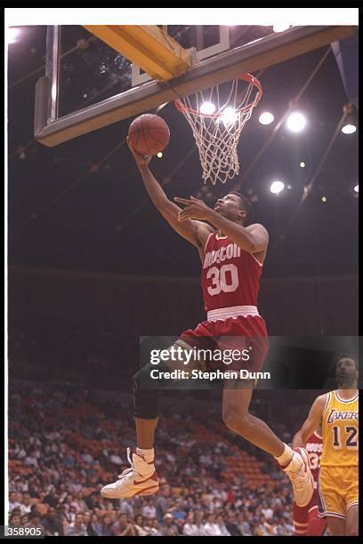 Guard Kenny Smith of the Houston Rockets goes up for two during a game against the Los Angeles Lakers at the Great Western Forum in Inglewood,...