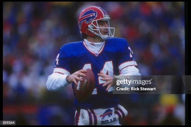 Quarterback Frank Reich of the Buffalo Bills looks to pass the ball during a playoff game against the Houston Oilers at Rich Stadium in Orchard Park,...