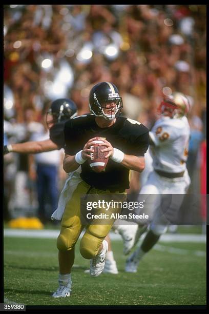 Quarterback Brett Favre of the Southern Mississippi Golden Eagles looks to pass while rolling out during the Golden Eagles 30-26 victory over the...