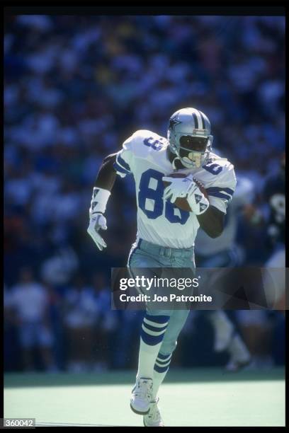 Wide receiver Michal Irvin of the Dallas Cowboys moves the ball during a game against the Cincinnati Bengals at Riverfront Stadium in Cincinnati,...