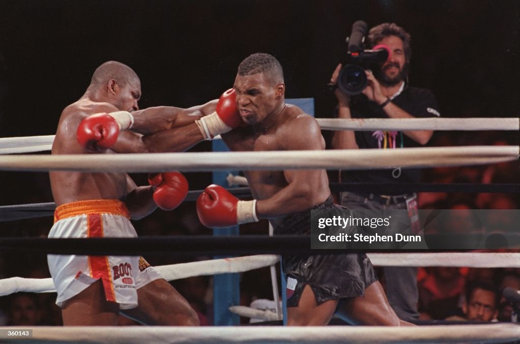 MIKE TYSON MISSES WITH THE A SHOT TO THE HEAD OF RAZOR RUDDOCK, WHILE ...