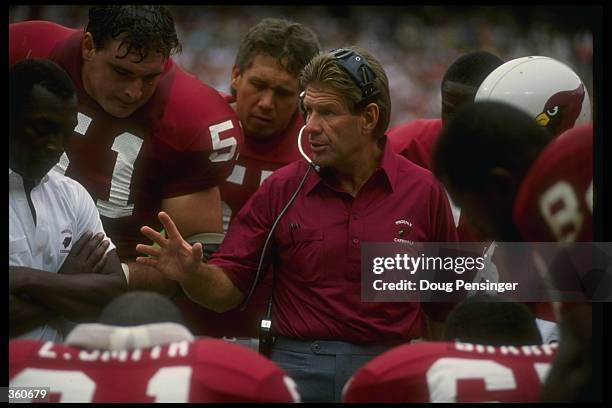 Phoenix Cardinals head coach Joe Bugel confers with his team during a game against the Washington Redskins at Sun Devil Stadium in Tempe, Arizona....