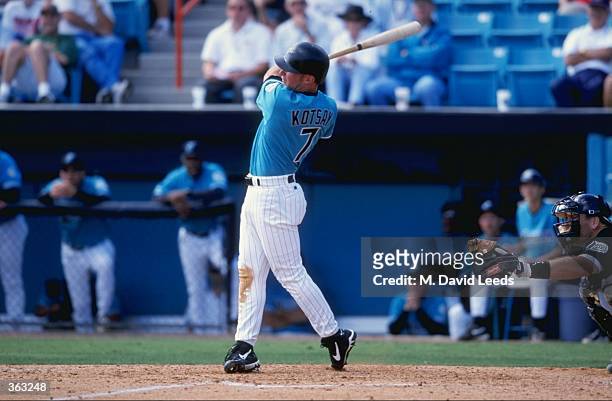Outfielder Mark Kotsay of the Florida Marlins swings at the ballduring the Spring Training game against the Tampa Bay Devil Rays at the Space Coast...
