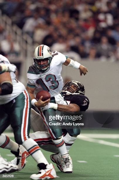 Quarterback Dan Marino of the Miami Dolphins in action against linebacker Cornelius Bennett of the Atlanta Falcons during the game at the Georgia...