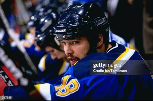 Tony Twist of the St. Louis Blues watches from the bench during the game against the Calgary Flames at the Canadian Airlines Saddledome in Calgary,...