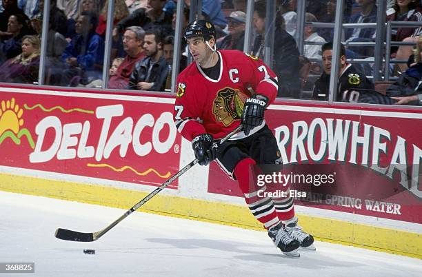 Chris Chelios of the Chicago Blackhawks controls the puck during the game against the Anaheim Mighty Ducks at the Arrowhead Pond in Anaheim,...