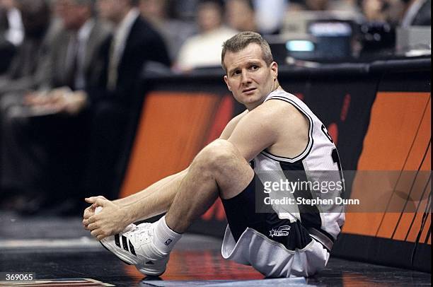 Andrew Gaze of the San Antonio Spurs stretches on the sidelines during the game against the Sacramento Kings at the Alamo Dome in San Antonio, Texas....