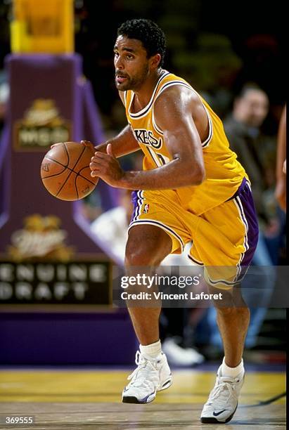 Rick Fox of the Los Angeles Lakers dribbles the ball during the game against the Charlotte Hornets at the Great Western Forum in Inglewood,...