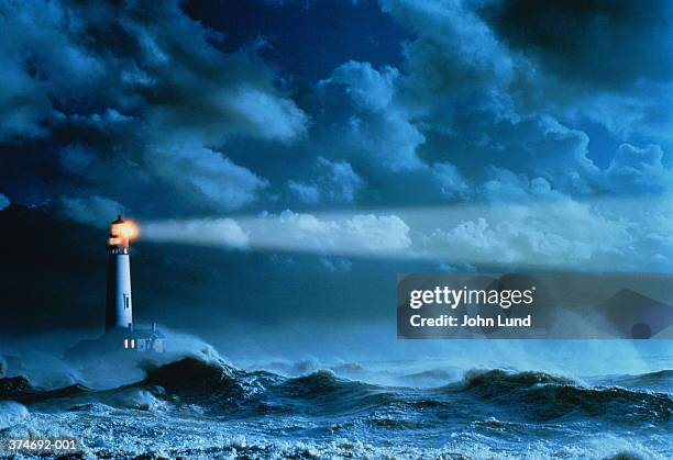 lighthouse casting beam of light over stormy sea (enhancement) - storm lighthouse stock pictures, royalty-free photos & images