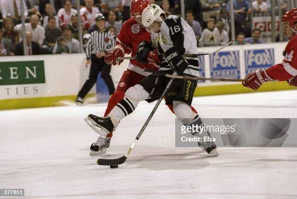 Pat Verbeek of the Dallas Stars and Viacheslav Fetisov of the Detroit Red Wings battle for the puck during a Western Conference Final Playoff game at...