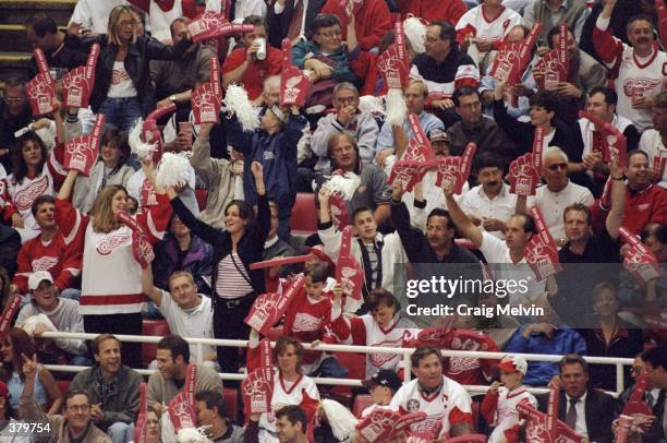 Fans cheer for the Detroit Red Wings during the NHL Stanley Cup Finals game against the Washington Capitals at the Joe Louis Arena in Detroit,...