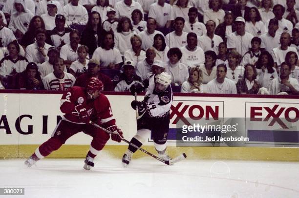 Defenseman Norm MacIver of the Phoenix Coyotes in action against defenseman Viacheslav Fetisov of the Detroit Red Wings during an NHL Playoffs game...