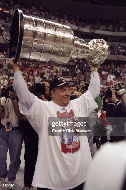 Scotty Bowman of the Detroit Red Wings holds up the Stanley Cup during the Stanley Cup Finals game against the Washington Capitals at the MCI Center...