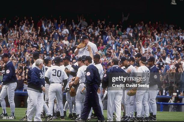 David Wells of the New York Yankees celebrates his perfect game against the Minnesota Twins with his teammates at Yankee Stadium in the Bronx, New...