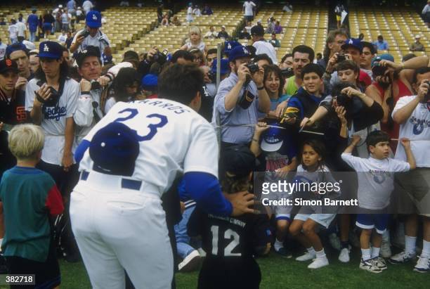 Infielder Eric Karros of the Los Angeles Dodgers talks with the fans before a game against the Colorado Rockies at Dodger Stadium in Los Angeles,...