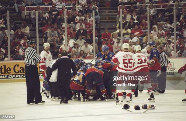 Teammates gather around Chris Pronger of the St. Louis Blues after his heart stopped and he colapsed during a game against the Detroit Red Wings at...