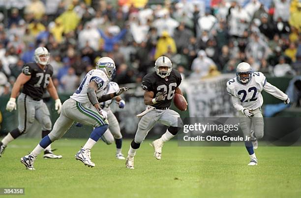 Running back Napoleon Kaufman of the Oakland Raiders carries the football during the Raiders 22-21 loss to the Seattle Seahawks at UMAX Coliseum in...