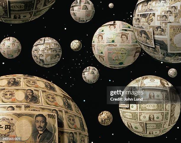 globes covered with various currencies suspended in space - all the money in the world stock-fotos und bilder