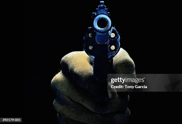 hand holding gun, front view, close-up (tinted b&w) - hand holding gun stockfoto's en -beelden