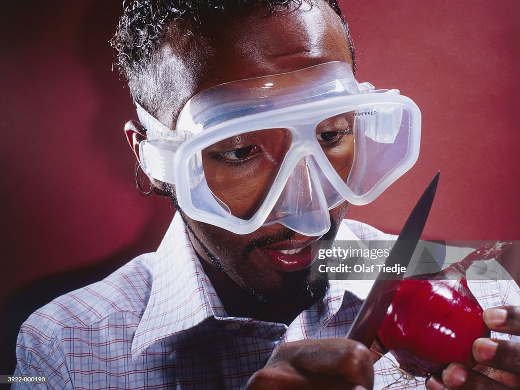 Man Wearing Mask to Cut Onion