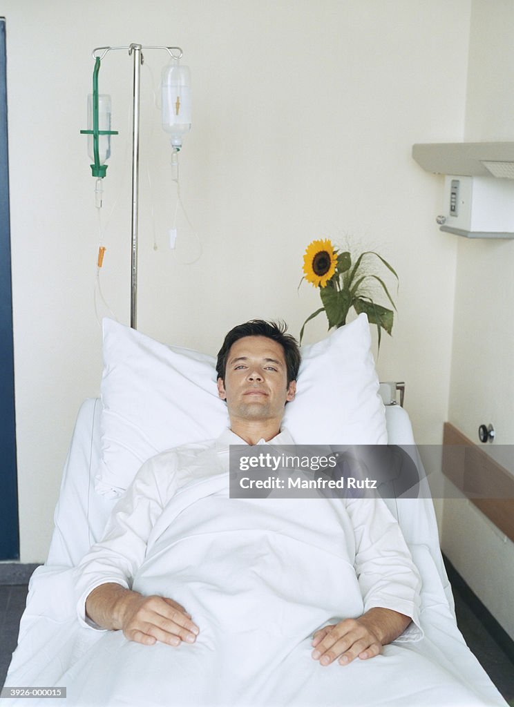 Man Reclining in Hospital Bed