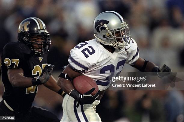 David Allen of the Kansas State Wildcats runs as Clarence Jones of the Missouri Tigers looks to tackle at Faurot Fiald in Columbus, Missouri. Kansas...