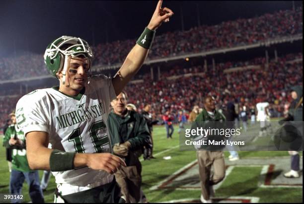 Quarterback Bill Burke of the Michigan State Spartans celebrates following a game against the Ohio State Buckeyes at the Ohio Stadium in Columbus,...