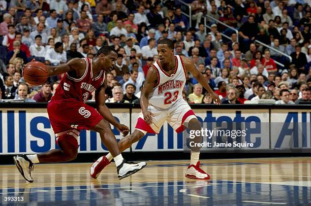 Kris Weems of the Stanford Cardinal dribbles as Steve Francis of the Maryland Terrapins guards during the BB&T Classic at the MCI Center in...