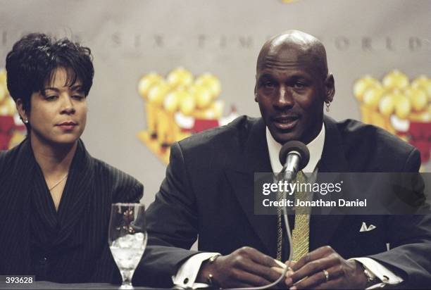 Michael Jordan of the Chicago Bulls and his wife Juanita during a press conference to anounce Jordans retirement at the United Center in Chicago,...
