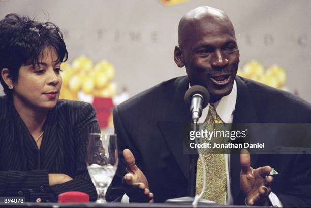 Michael Jordan of the Chicago Bulls and his wife Juanita during a press conference to anounce Jordans retirement at the United Center in Chicago,...