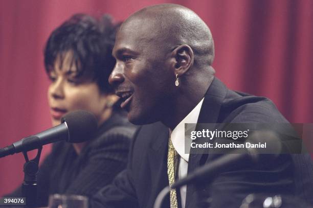 Michael Jordan of the Chicago Bulls and his wife Juanita during a press conference to anounce Jordans retirement at the United Center in Chicago,...