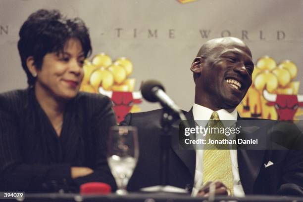 Michael Jordan of the Chicago Bulls and his wife Juanita during a press conference to anounce Jordans retirement at the United Center in Chicago,...