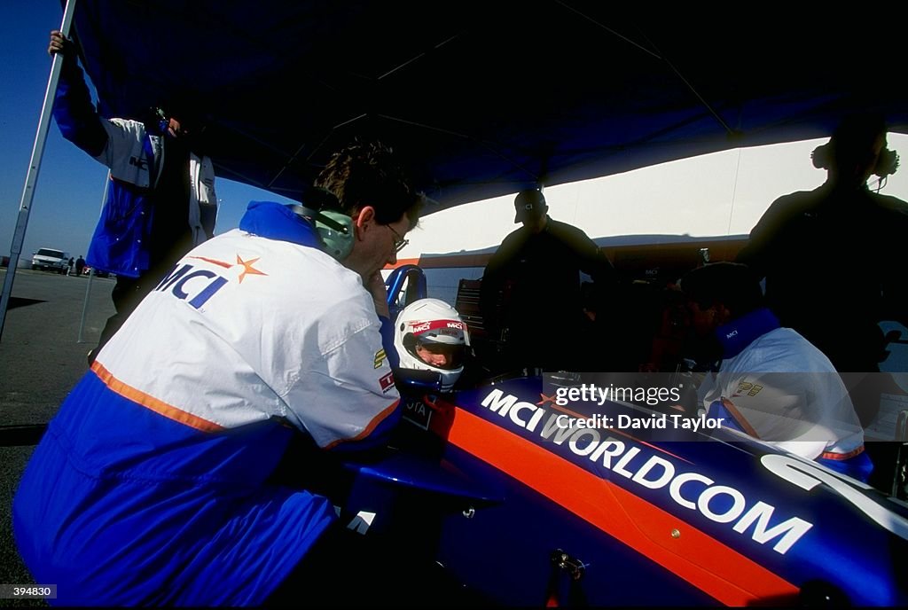 David Besnard Racing David Besnard of Australia sits in his car while technicians work on ...