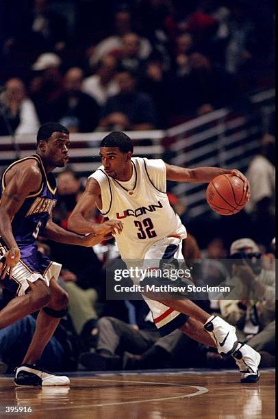 Guard Richard Hamilton of the University of Connecticut Huskies in action against guard Deon Luton of the Washington Huskies during the Great Eight...