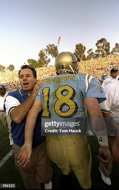 Quarterback Cade McNown and head coach Bob Toledo of the UCLA Bruins celebrate during the game against the USC Trojans at the Rose Bowl in Pasadena,...