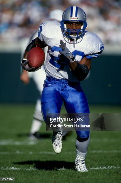 Barry Sanders of the Detroit Lions carries the ball during the game against the Jacksonville Jaguars at Alltel Stadium in Jacksonville, Florida. The...