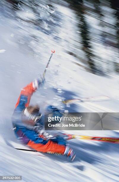 skier falling with trees in background (blurred motion) - wipeout sportunfall stock-fotos und bilder