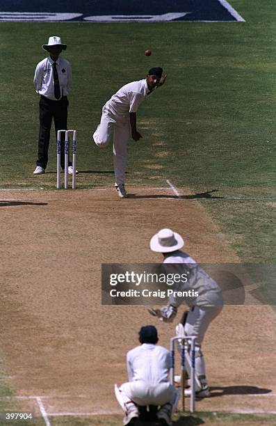Harbajan Singh of India shows his bowling skills against Australia''s Mark Taylor during the match between India and Australia in the third test...