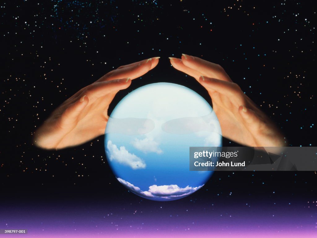 Fortune tellers hands and crystal ball