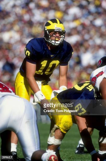 Quarterback Tom Brady and offensive lineman David Brandt of the Michigan Wolverines in action during the game against the Indiana Hoosiers at the...
