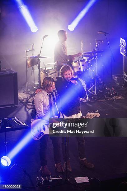 Tim Foreman , Jon Foreman and drummer Chad Matthew Butler of Switchfoot perform on stage at The Moore Theater on November 15, 2013 in Seattle,...