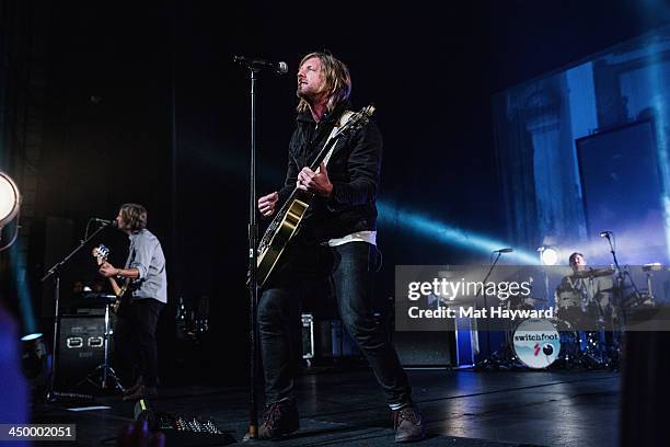 Tim Foreman , Jon Foreman and drummer Chad Matthew Butler of Switchfoot perform on stage in front of a sold out crowd at The Moore Theater on...