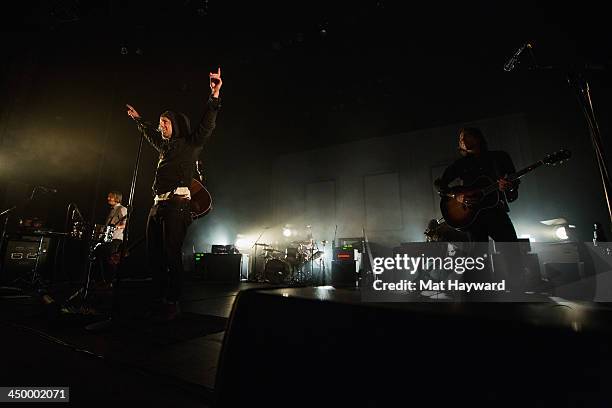 Tim Foreman , Jon Foreman and Drew Shirley of Switchfoot perform on stage in front of a sold out crowd at The Moore Theater on November 15, 2013 in...