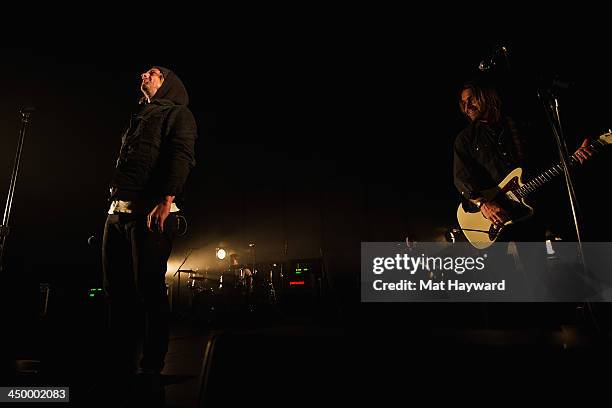 Jon Foreman and Drew Shirley of Switchfoot perform on stage in front of a sold out crowd at The Moore Theater on November 15, 2013 in Seattle,...