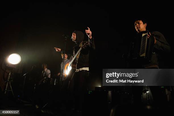 Tim Foreman, Chad Matthew Butler, Jon Foreman and Jerome Fontamillas of Switchfoot perform on stage in front of a sold out crowd at The Moore Theater...