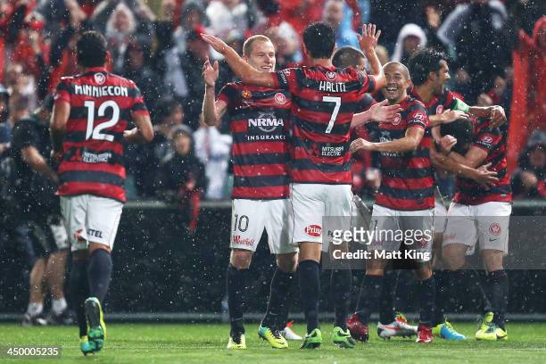 Wanderers players celebrate the goal to Mark Bridge during the round six A-League match between the Western Sydney Wanderers and the Melbourne...