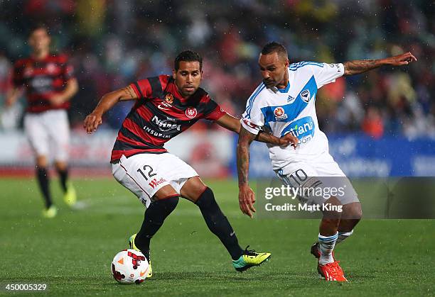 Tahj Minniecon of the Wanderers competes with Archie Thompson of the Victory during the round six A-League match between the Western Sydney Wanderers...